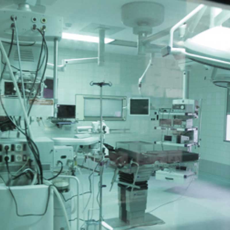 Ein leeres Operationssaal mit medizinischer Ausrüstung und OP-Tisch.